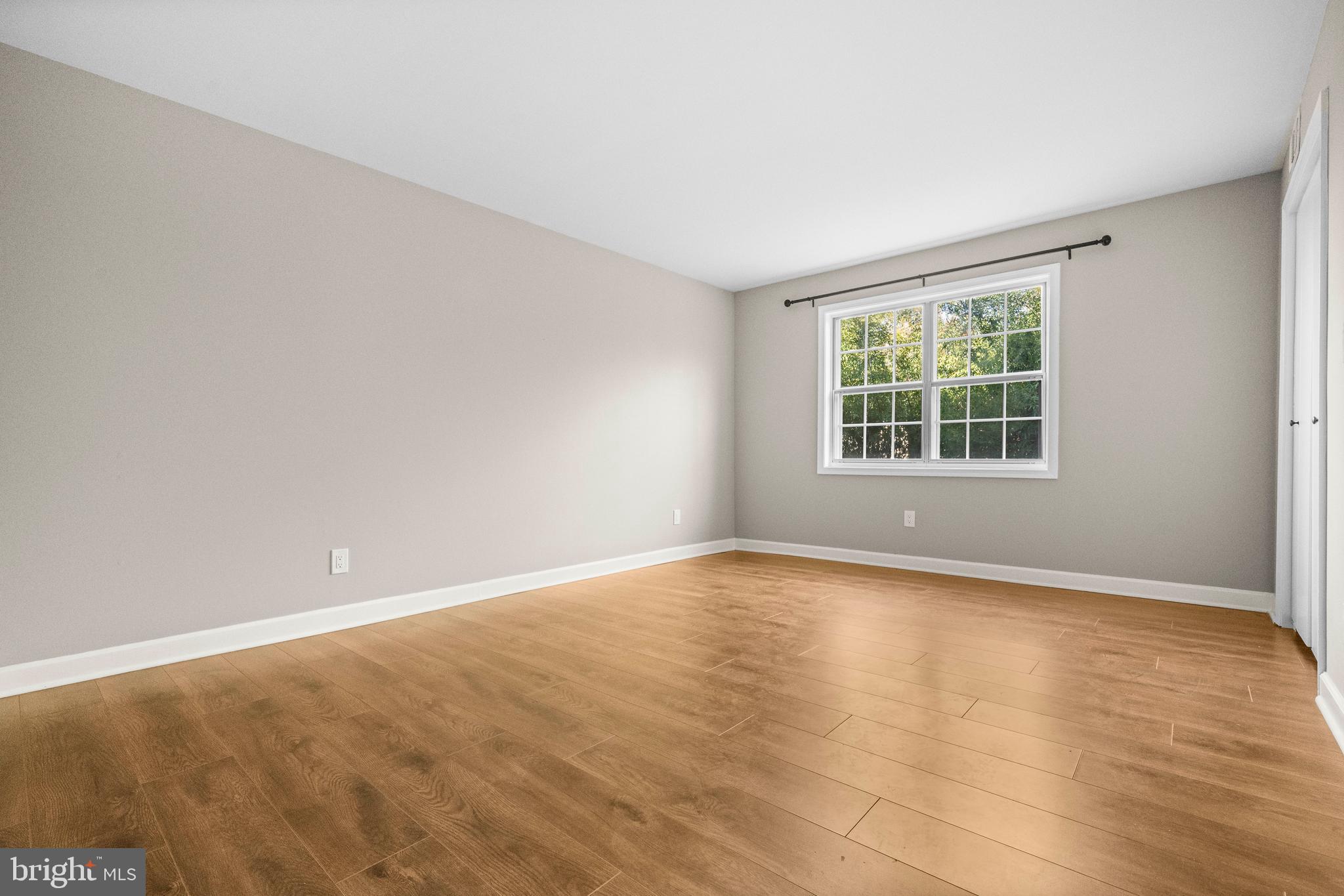 1134 South Washington Street, Unit T1 Falls Church, VA 22046 - Photo 20 of 34 wooden floor in an empty room with a window