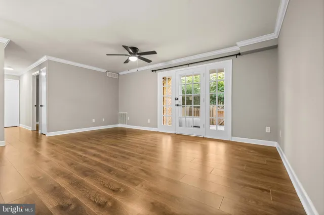 wooden floor in an empty room with a window