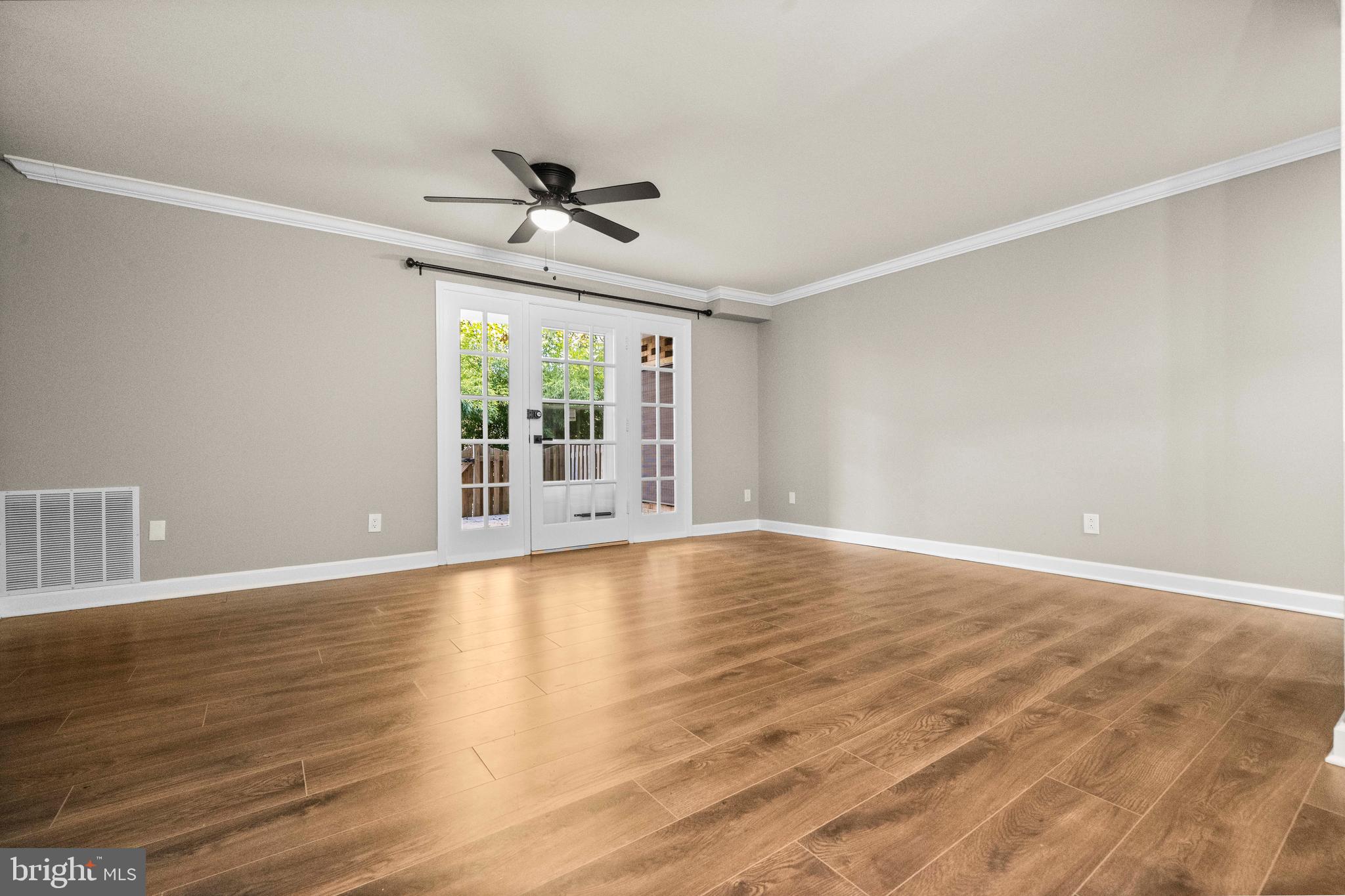 1134 South Washington Street, Unit T1 Falls Church, VA 22046 - Photo 10 of 34 a view of an empty room with wooden floor and a window