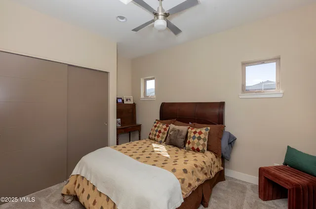 a bedroom with a bed and a chair