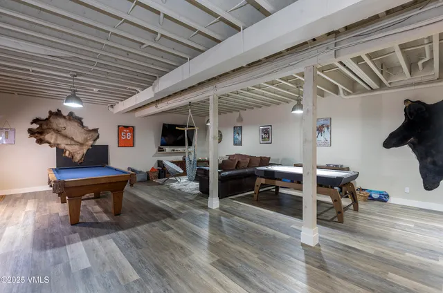 a living room with furniture and wooden floors