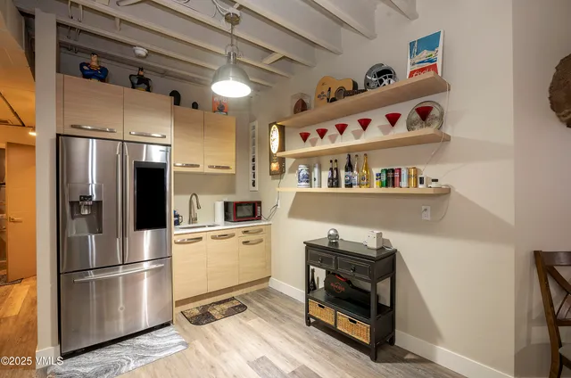a kitchen with stainless steel appliances a refrigerator and a stove top oven