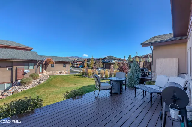 a view of a patio with dining table and chairs with wooden floor
