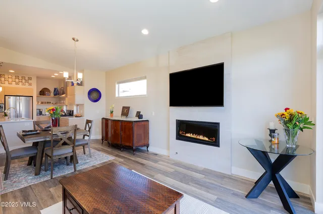 a living room with furniture a flat screen tv and a fireplace