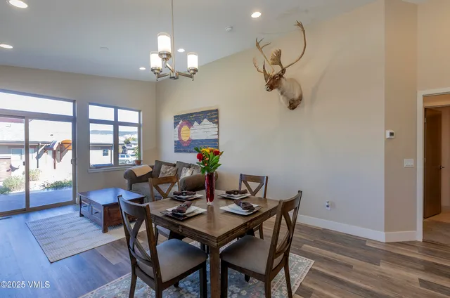 a view of a dining room with furniture wooden floor and chandelier