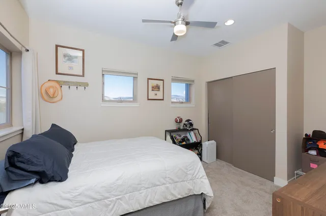 a bedroom with a bed and cabinets