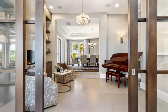 a living room with furniture kitchen view and a large window