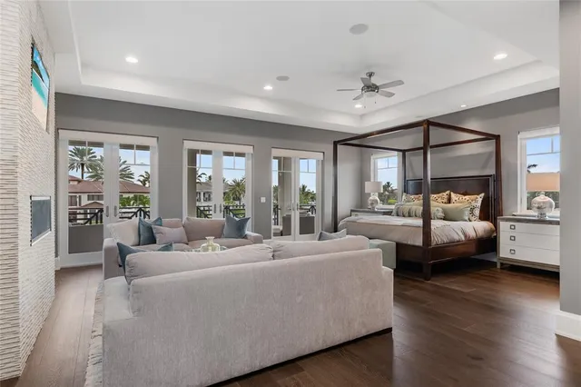a bedroom with a bed and a flat tv screen on dresser