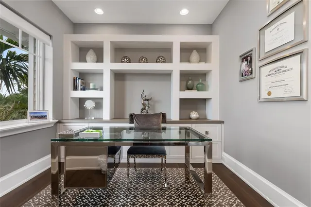 a living room with furniture and a large mirror with potted plant