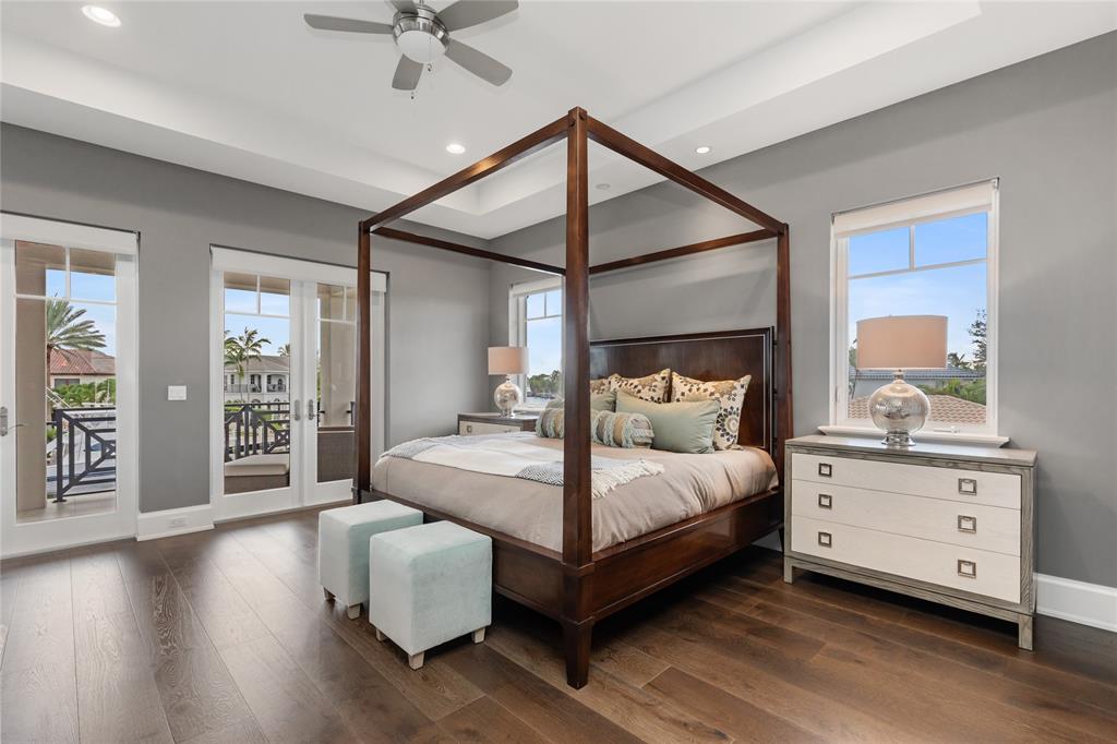 3211 Northeast 27th Avenue Lighthouse Point, FL 33064 - Photo 49 of 98 a bedroom with a large bed and a chandelier