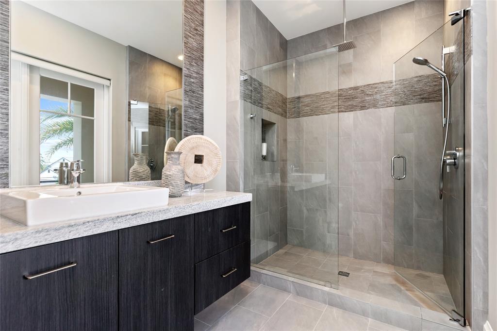 3211 Northeast 27th Avenue Lighthouse Point, FL 33064 - Photo 76 of 98 a bathroom with a shower sink and mirror