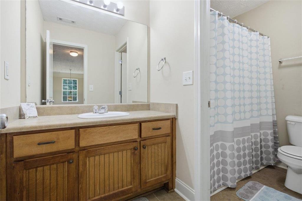 1231 Hillview Road Hampton, GA 30228 - Photo 24 of 49 a bathroom with a sink a toilet and shower