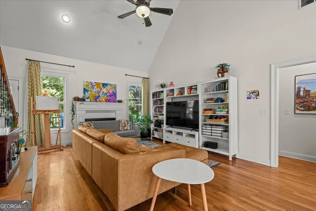 a living room with furniture and a potted plant