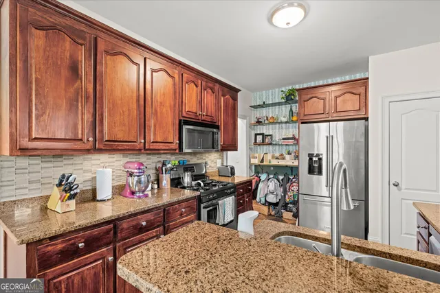 a kitchen with a sink stove and cabinets
