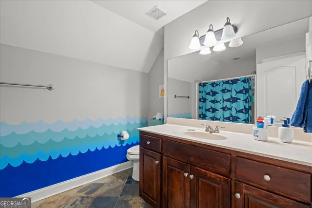 a bathroom with a shower and a curtain