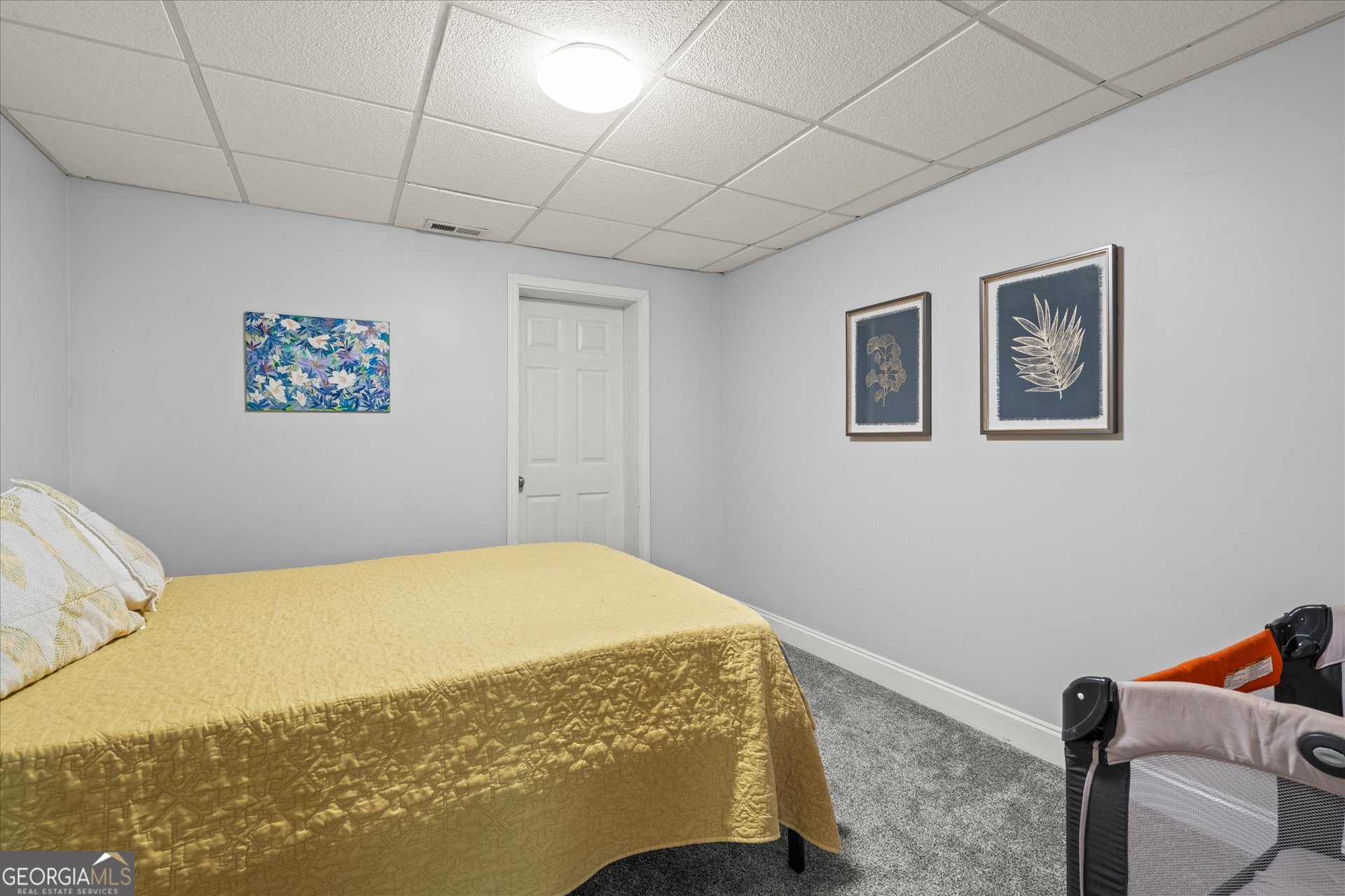 207 Retreat Way Carrollton, GA 30116 - Photo 36 of 41 a bedroom with a bed and a painting on the wall