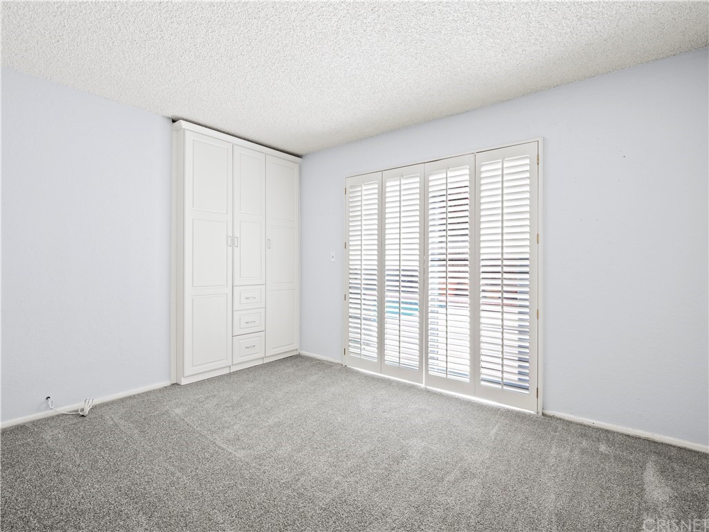 25656 Yucca Valley Road Valencia, CA 91355 - Photo 25 of 49 Downstairs bedroom has built-in storage in lieu of regular closet