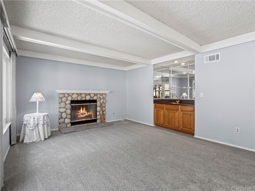 25656 Yucca Valley Road Valencia, CA 91355 - Photo 36 of 49 River rock fireplace in family room