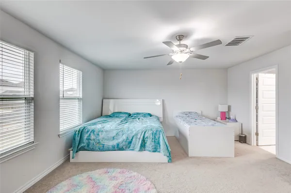 a bedroom with bed and window