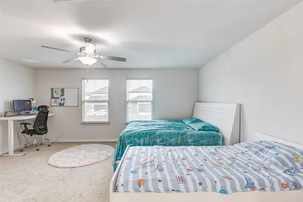 a bedroom with furniture and a wooden floor