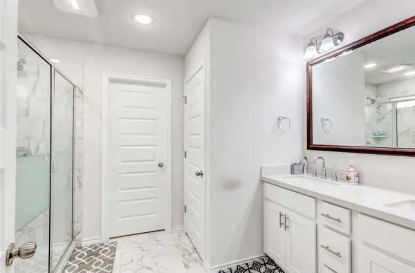 a bathroom with a shower sink and mirror