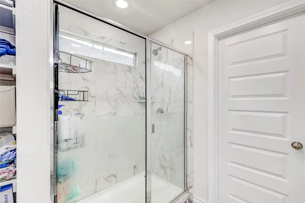 a bathroom with a glass shower door