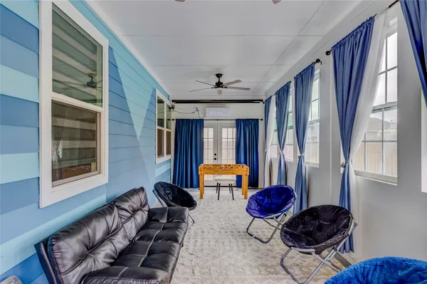 a living room with furniture and large windows