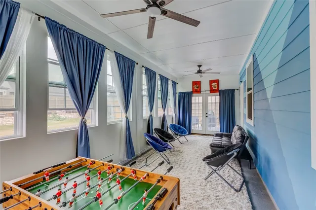 a living room with furniture and large windows