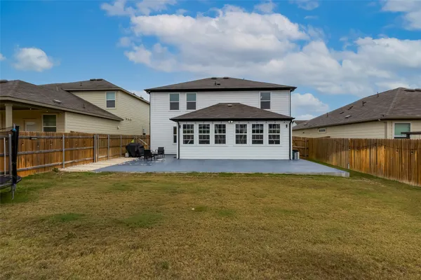 a view of a house with a swimming pool and deck