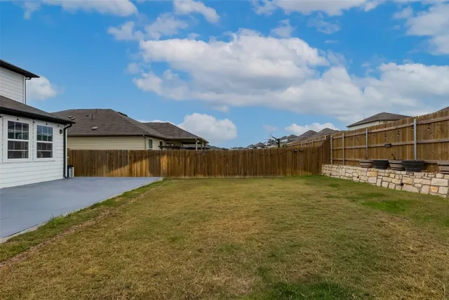 a view of a house with a swimming pool and deck