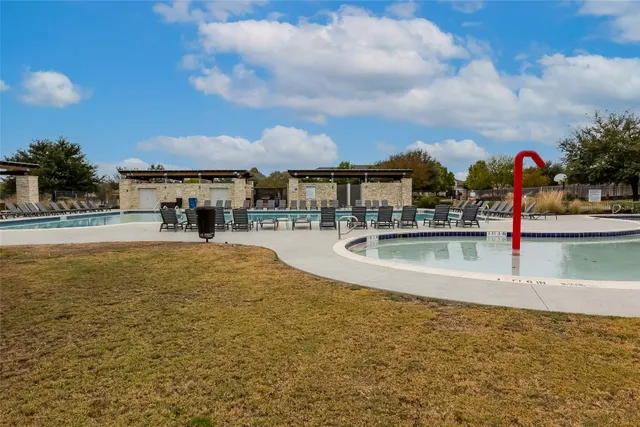 a view of a swimming pool with an outdoor seating