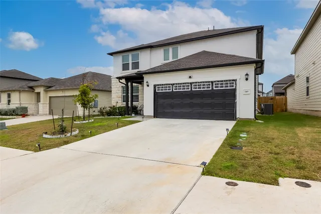 a front view of a house with a yard