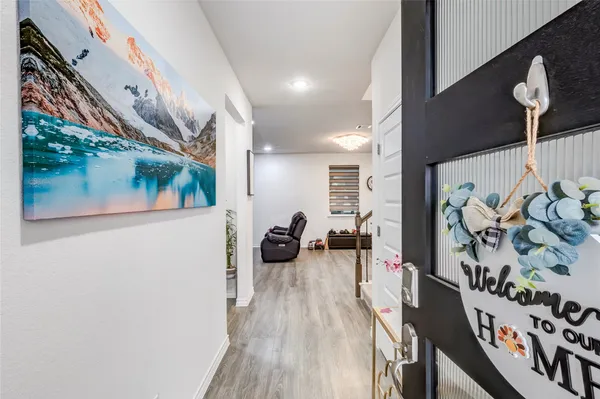 a hallway with wooden floor and furniture
