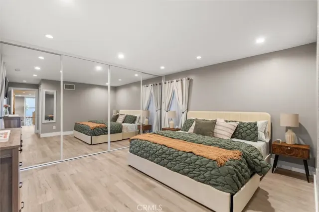 a bedroom with furniture and wooden floor