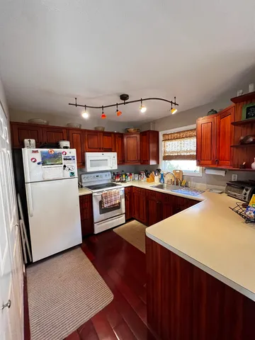 a view of a kitchen from the hallway with a couch