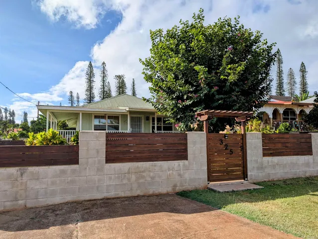 a front view of house with a garden