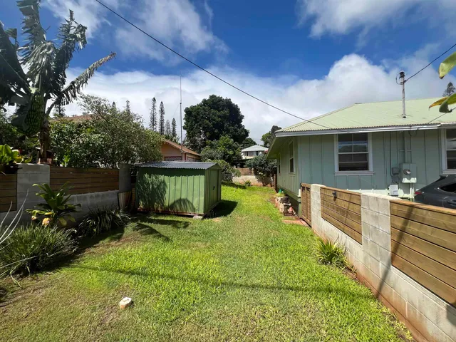 a view of a porch with furniture and a yard