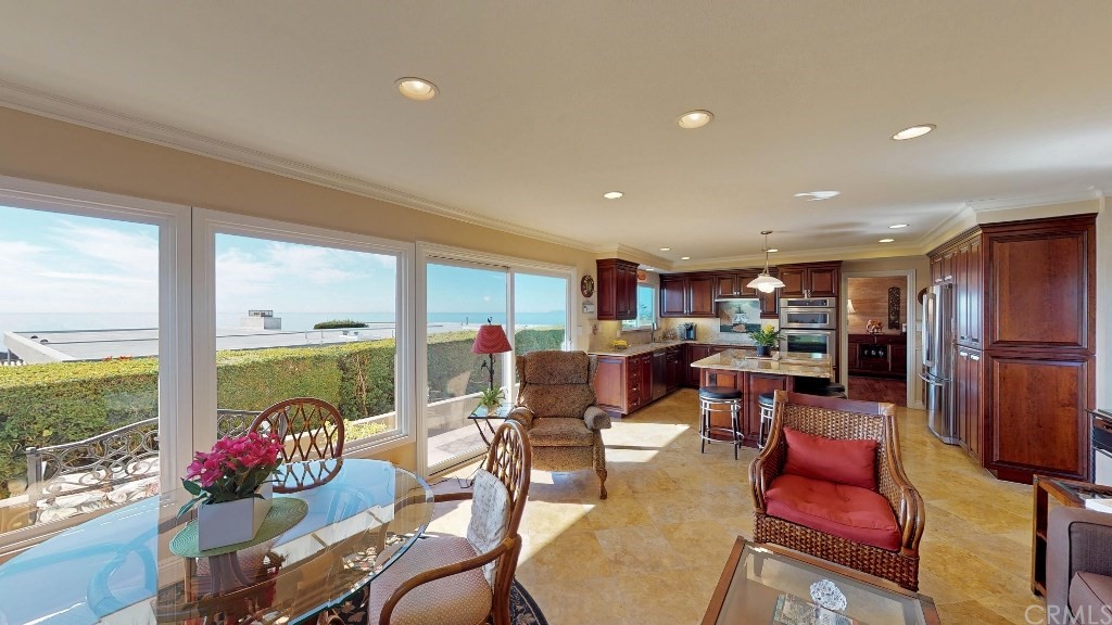 119 Monarch Bay Drive Dana Point, CA 92629 - Photo 18 of 24 a living room with lots of furniture and a dining table with floor to ceiling windows