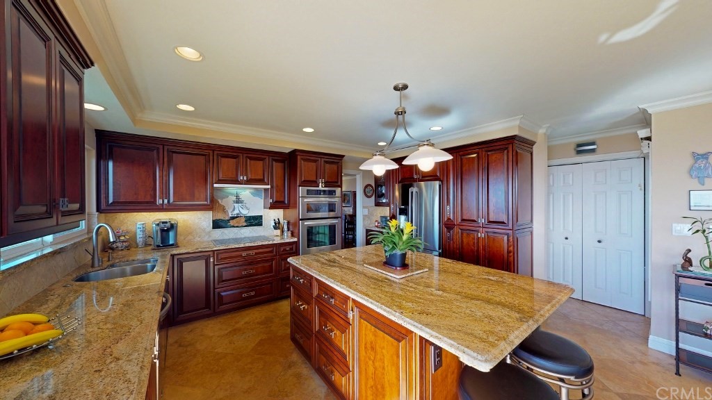 119 Monarch Bay Drive Dana Point, CA 92629 - Photo 20 of 24 a kitchen with stainless steel appliances granite countertop a sink refrigerator and cabinets