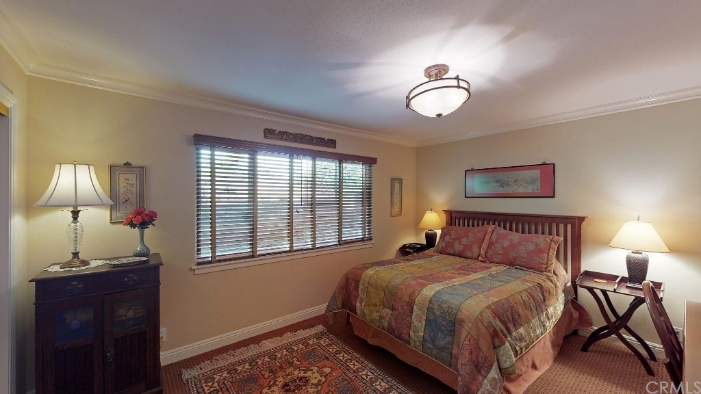 119 Monarch Bay Drive Dana Point, CA 92629 - Photo 7 of 24 a bedroom with a bed and a window
