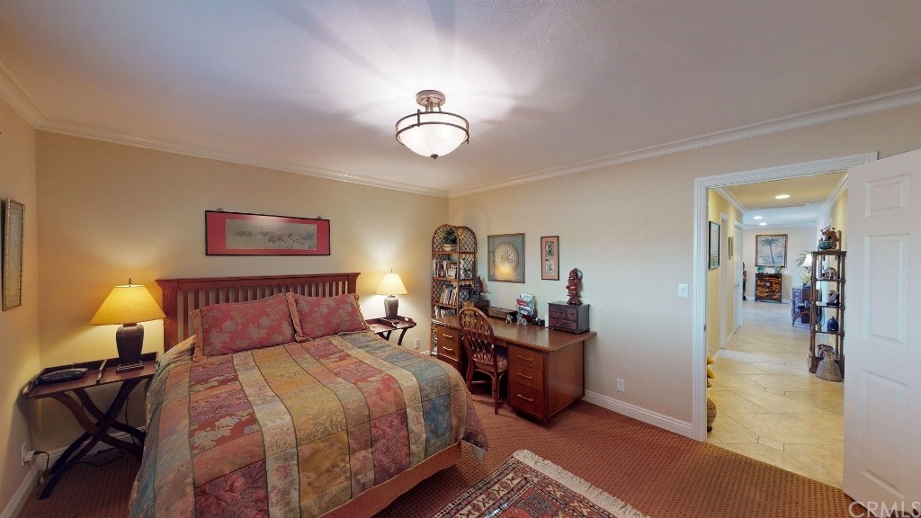 119 Monarch Bay Drive Dana Point, CA 92629 - Photo 8 of 24 a bedroom with a bed and a chandelier