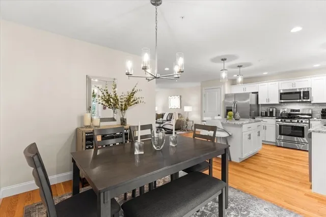 a view of a dining room with furniture and chandelier