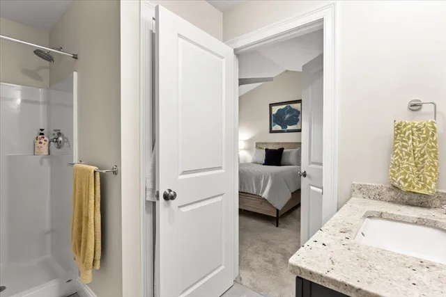a en suite bathroom with a sink and a mirror