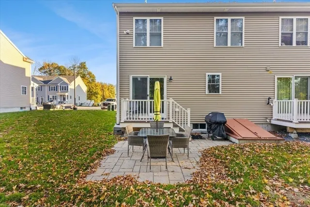 a view of a house with backyard and sitting area