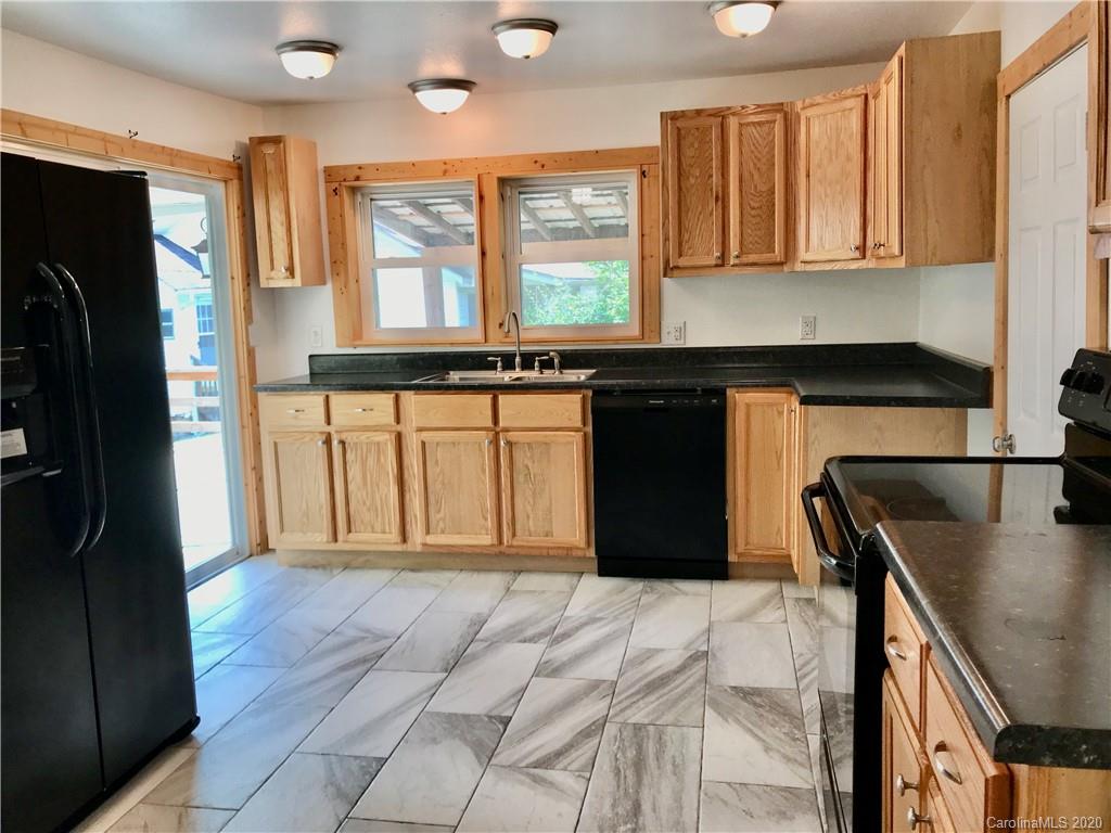 684 Holtzclaw Road Canton, NC 28716 - Photo 11 of 33 a kitchen with stainless steel appliances granite countertop a refrigerator and a stove top oven