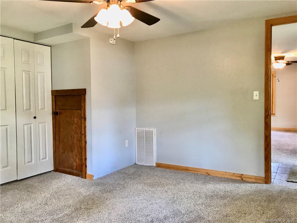 684 Holtzclaw Road Canton, NC 28716 - Photo 4 of 33 an empty room with closet and a chandelier fan