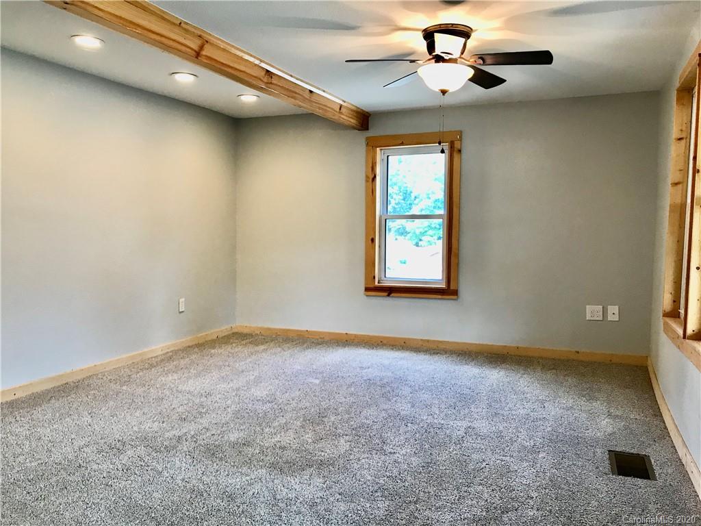 684 Holtzclaw Road Canton, NC 28716 - Photo 6 of 33 an empty room with windows and fan