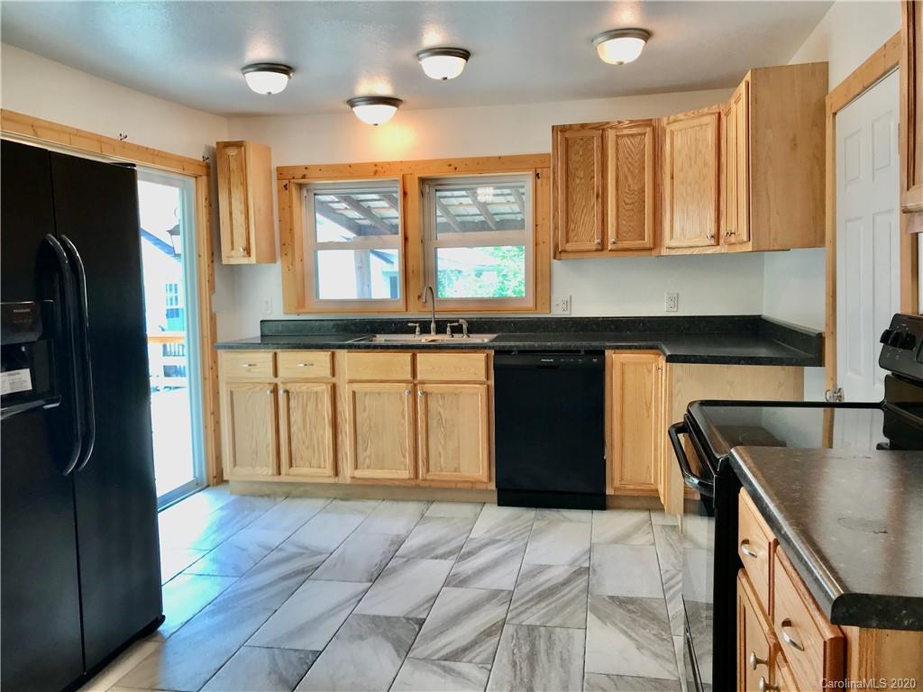 684 Holtzclaw Road Canton, NC 28716 - Photo 9 of 33 a kitchen with stainless steel appliances granite countertop a refrigerator and stove