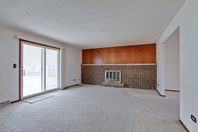 601 West Golf Road Libertyville, IL 60048 - Photo 11 of 27 a view of an empty room with a fireplace and a window