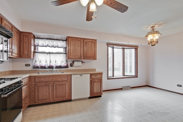 601 West Golf Road Libertyville, IL 60048 - Photo 9 of 27 a kitchen with stainless steel appliances granite countertop a stove a sink dishwasher and a microwave oven
